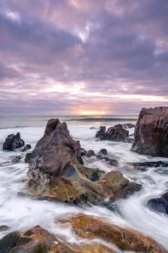Sunset at the rocky beach at Vila Nova de Gaia, Portugal Stock Photos