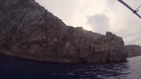 Sunset at the rocky cliff during a summer boat  sea excursion Stock Footage 119494257