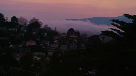 Sunset: rolling mists pass over homes built in the hills of Sausalito California Stock Footage 94085161
