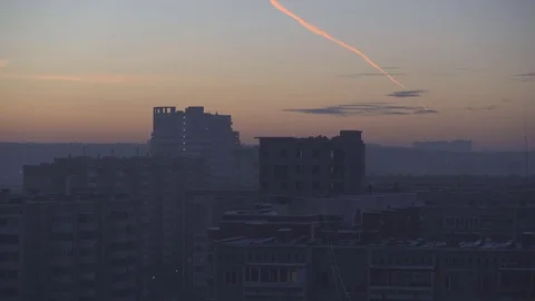 Sunset in the Russian city. There is a trail from the flying plane in the sky. Stock Footage 84434496