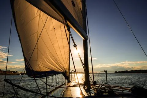 Sunset at the Sailboat deck while cruising sailing at opened sea or river. Yacht Stock Photos