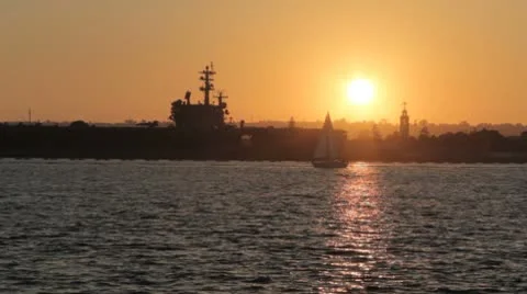 Sunset with sailboat USN Ronald Reagan Video stock 8923853