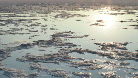 Sunset on a salt lake, reflections of sunlight on the water surface Stock Footage 123895040