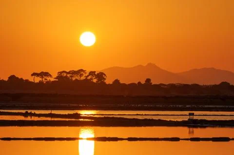 Sunset at the saltpans of Trapani Stock Photos