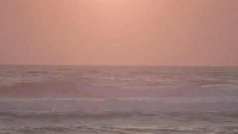 Sunset  on sand beach with waves slow motion 動画素材 233353822