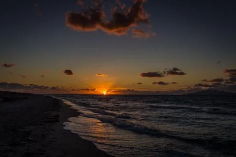 Sunset on sandy Alikes beach near Tigaki  with dramatic cloudy sky Stock Photos