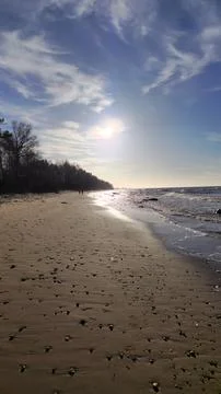 Sunset at Sandy Beach with Gentle Waves Stock Photos