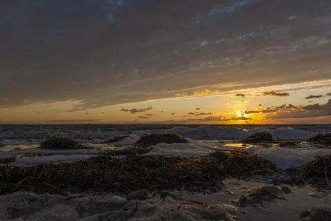 Sunset on a sandy beach. Ground-level shot. Inbserl Fehmarn, Germany Stock Photos
