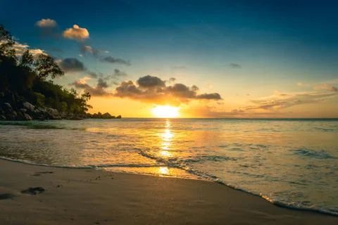 Sunset at a sandy beach in Seychelles Stock Photos