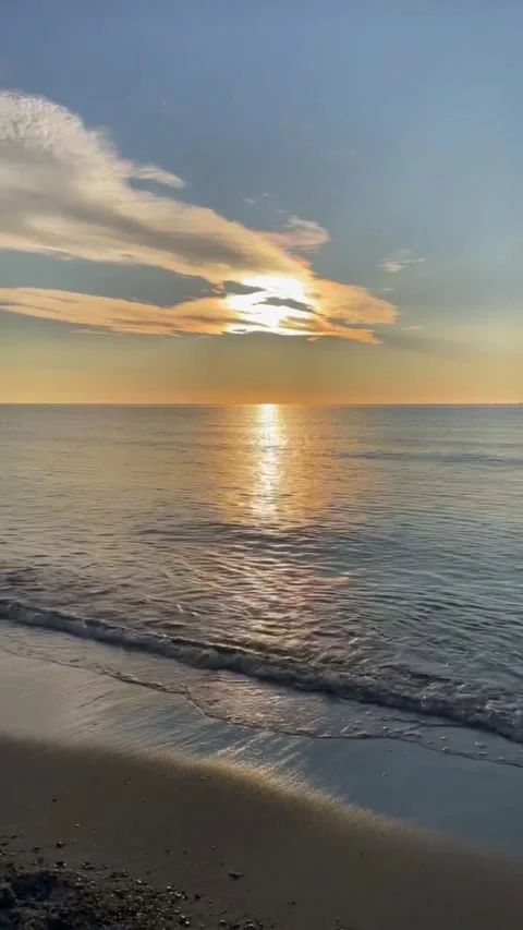 Sunset on the sandy seashore. Light foamy waves. Relaxing atmosphere Stock Footage 274347198