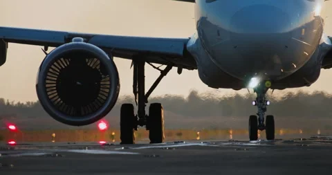 Sunset Scene of Airplane Wheels and Turbine on Runway Stock Footage 293292626