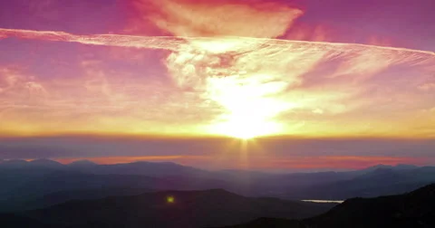 Sunset scene with mountains in background Stockbeeldmateriaal 58787264