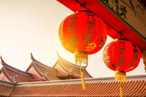 Sunset scene of red lanterns decorations hanging on chinese temple roof . Stock Photos