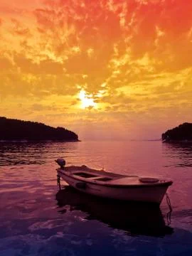 Sunset scene with small boat Stockfoto's