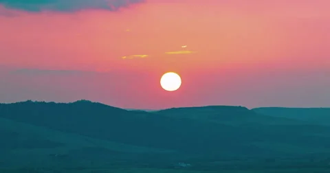 Sunset scene with sun fall behind the violet clouds in background Stock Footage 67634936