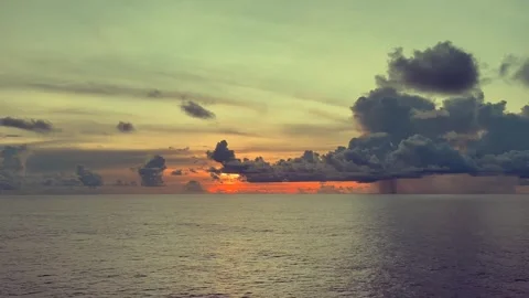 Sunset scene with vibrant colors over the ocean, with dramatic clouds in th.. Stock Footage 338282220