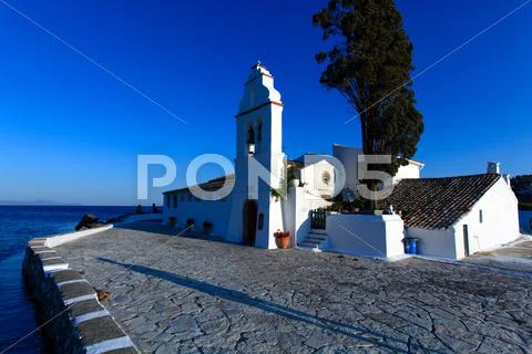 Sunset scene of vlacherna monastery, kanoni, corfu, greece Stock Photos