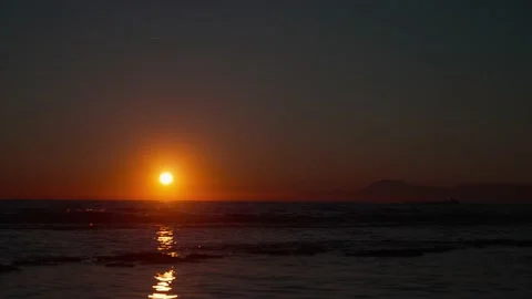 Sunset on the sea against the backdrop of mountains Stock Footage 239546111