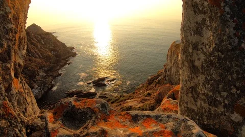 SUNSET IN THE SEA BETWEEN ROCKS Stock Footage 94230341