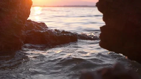 Sunset Sea Between Rocky Cliffs With Gentle Waves and Golden Light on Water Stock Footage 337701507