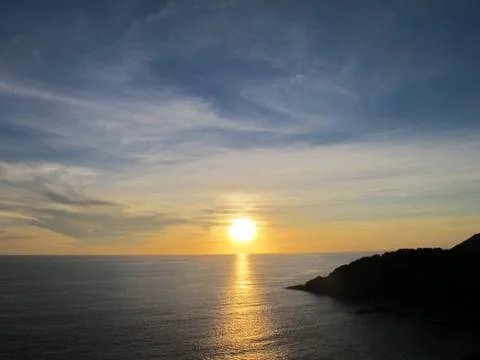 Sunset at sea with a cape 写真素材