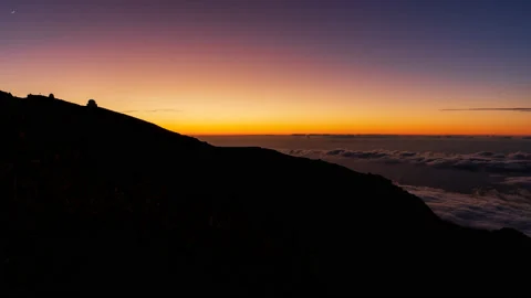 Sunset with sea of clouds, rising moon and astronomical observatory silhouette Stock-Footage 211035480