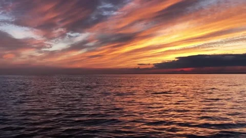 Sunset at sea, dramatic sky in crimson, red, orange tones waves Stock Footage 293500299