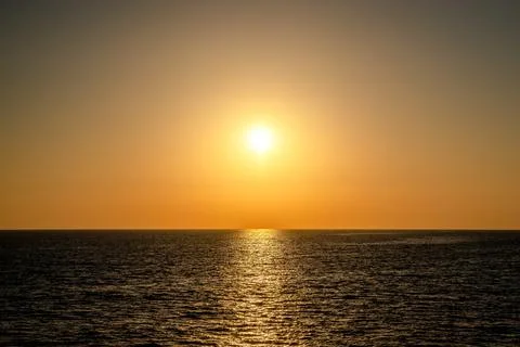 Sunset into the sea horizontal 写真素材