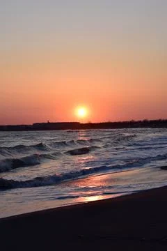 Sunset sea landscape. Warm March day, calm sea. Stock Photos