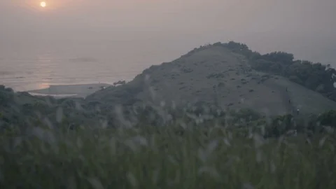 Sunset at sea, mountains in background Stock Footage 71382690