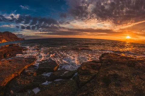 Sunset by the sea Stock Photos