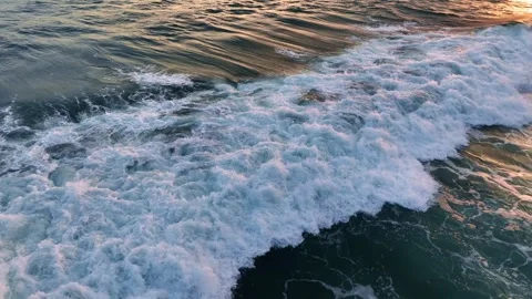 Sunset at sea, powerful ocean wave crashing. Aerial shot of breaking surf with Stock Footage 251635697