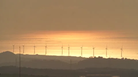 Sunset of the sea reflected in the waves, drone shot Stock Footage 303392556