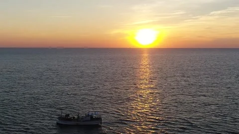 Sunset of the sea reflected in the waves, drone shot Video stock 303392562