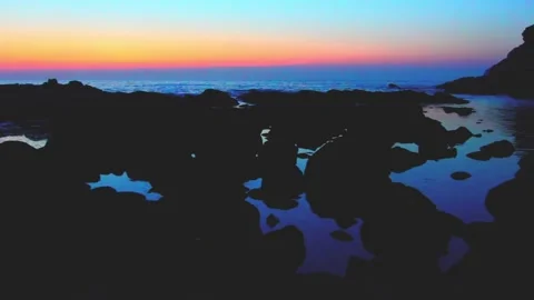 SUNSET IN THE SEA WITH ROCKS Stock Footage 94258839