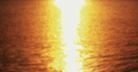Sunset By The Sea - Seamless loop of a defocused shot of a wavy water surface Stock-Footage 79656010