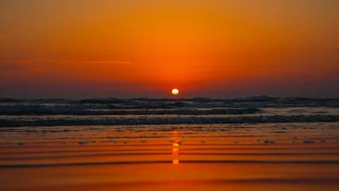 Sunset into the sea. Selective focus. Shallow depth of field. Background blur Stock Photos