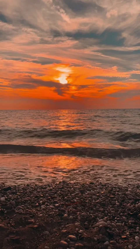 Sunset on the sea shore bright red + noise of the sea Stock Footage 297106988