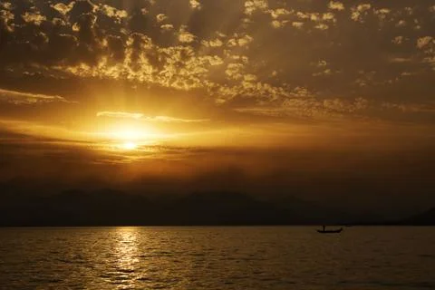 Sunset on the sea side with silhouettes Stock Photos