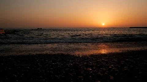 Sunset in sea, stunning sun reflection in pebble stone Video stock 105207591