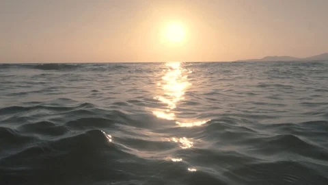 Sunset at sea, sun reflection on water surface. Ocean waves at sunset Stock Footage 120581234