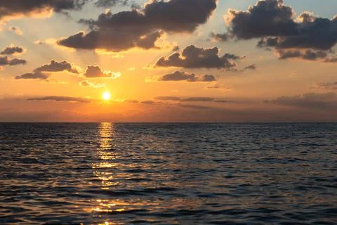 Sunset on the sea with a sunny path Stock Photos