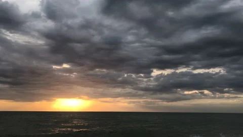 Sunset at the sea. Thick clouds in the evening sky over the sea. Timelapse. Stock Footage 135993756