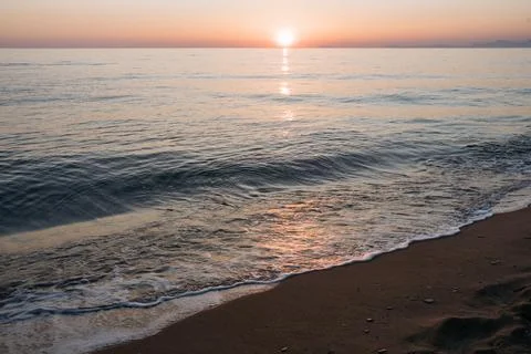 Sunset at the sea with waves Stock Photos