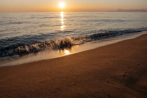 Sunset at the sea with waves Stock Photos