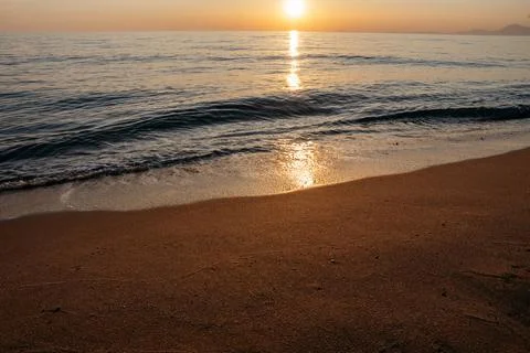 Sunset at the sea with waves Stock Photos