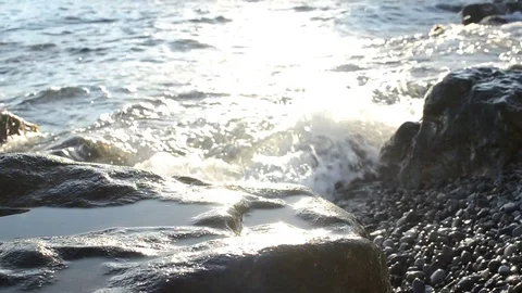 Sunset sea waves storm stone wild beach 库存影片 99187974