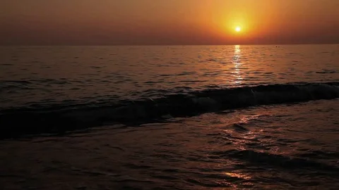 The Sunset on the sea. A waves upon the sand Stock Footage 125781818