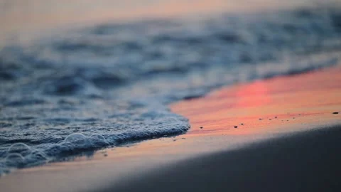 Sunset on the sea. Waves wash the sandy shore Stock Footage 286153612