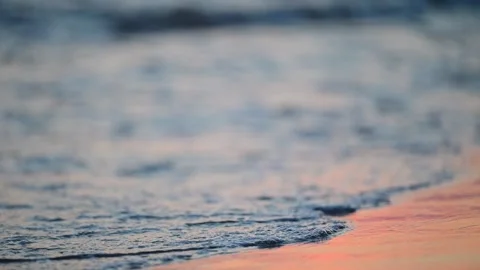 Sunset on the sea. Waves wash the sandy shore, 4k footage Stock Footage 287954527